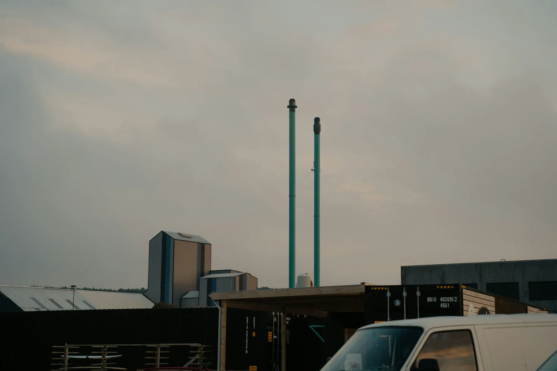 A white work van parked outside an industrial unit