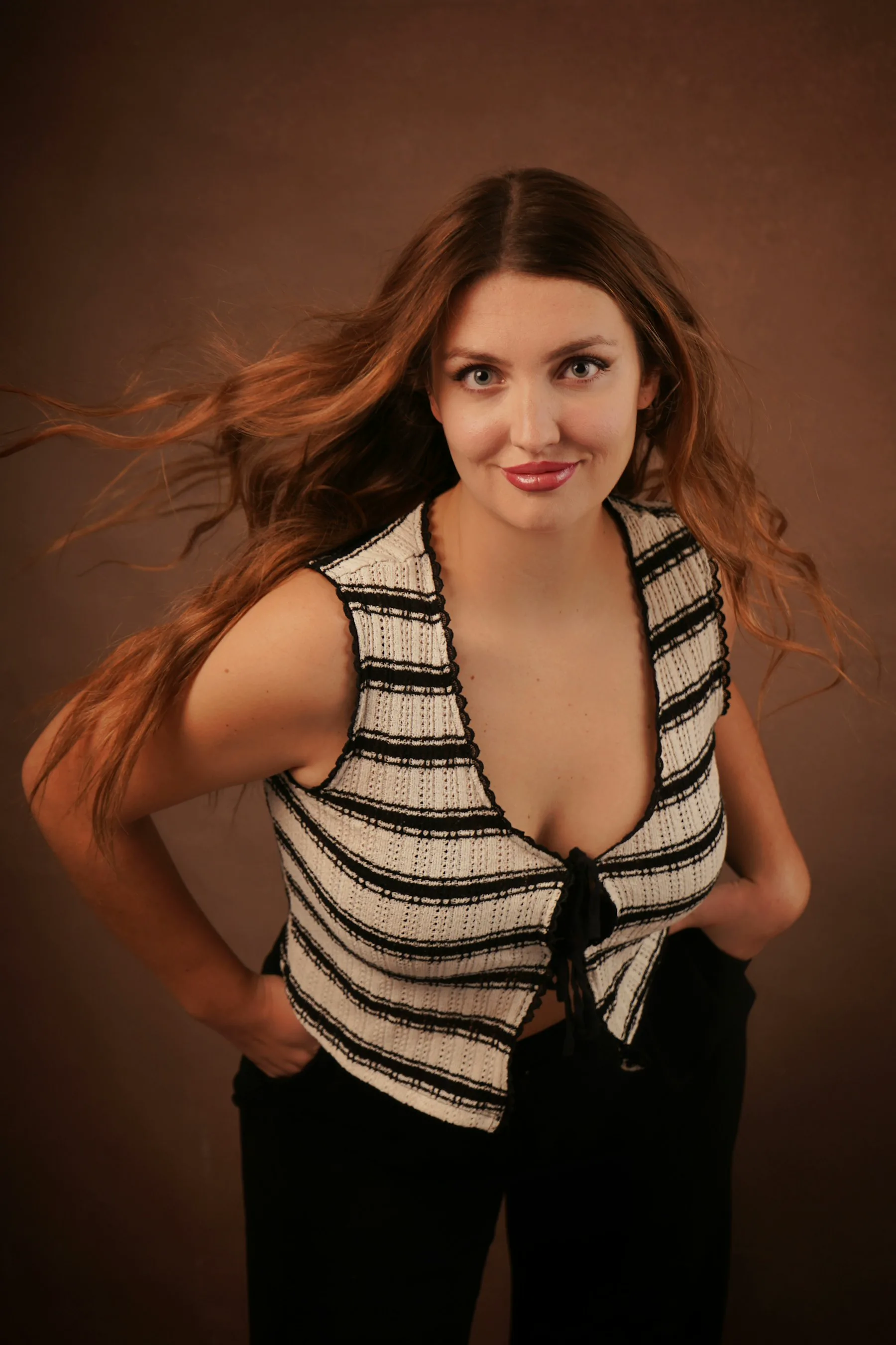 Long copper-brown hair styled in soft waves